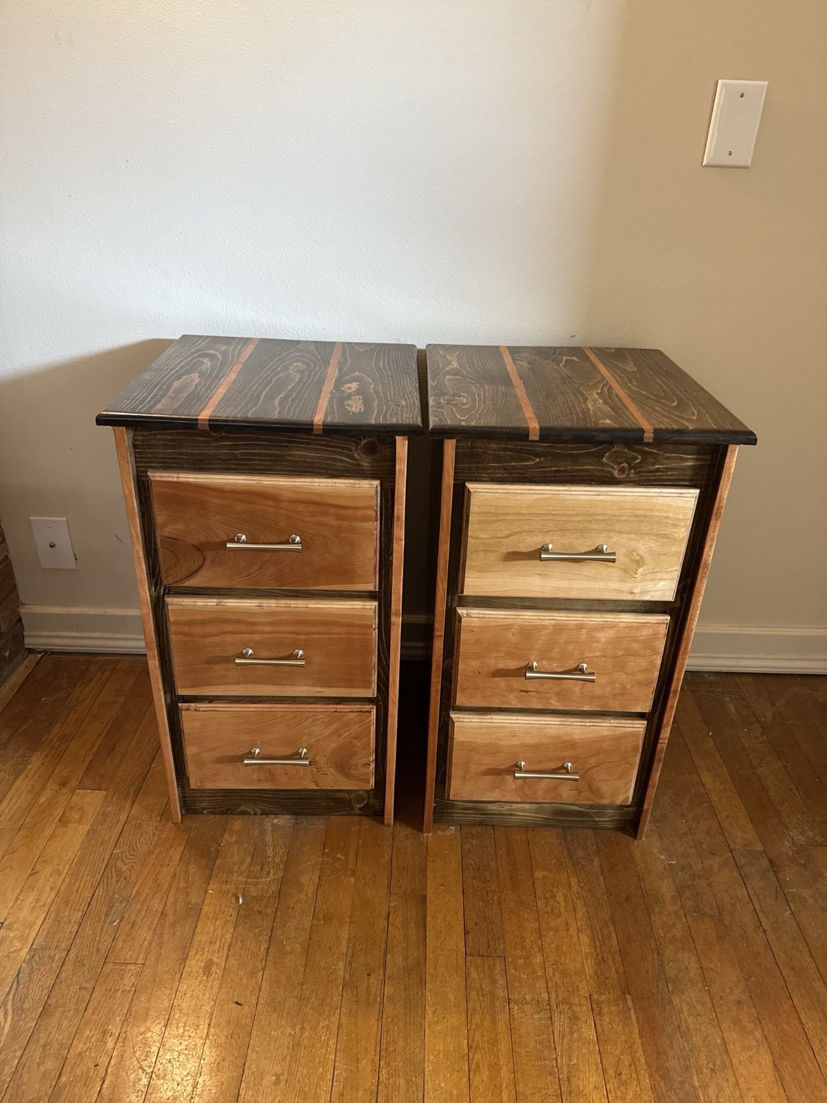 Custom-built matching cherry wood nightstands with stained frames